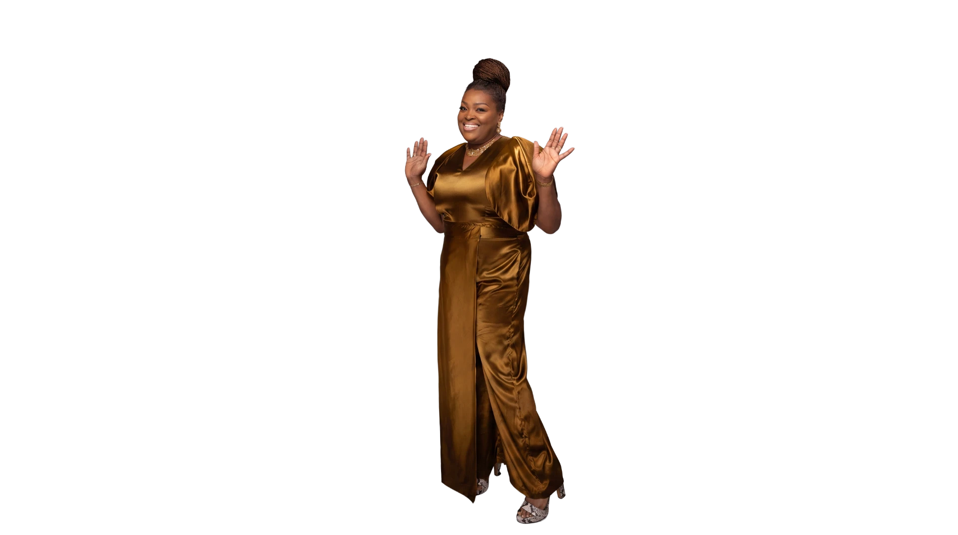 Ps Toun Fadugba, smiling in a golden-brown satin dress with raised hands